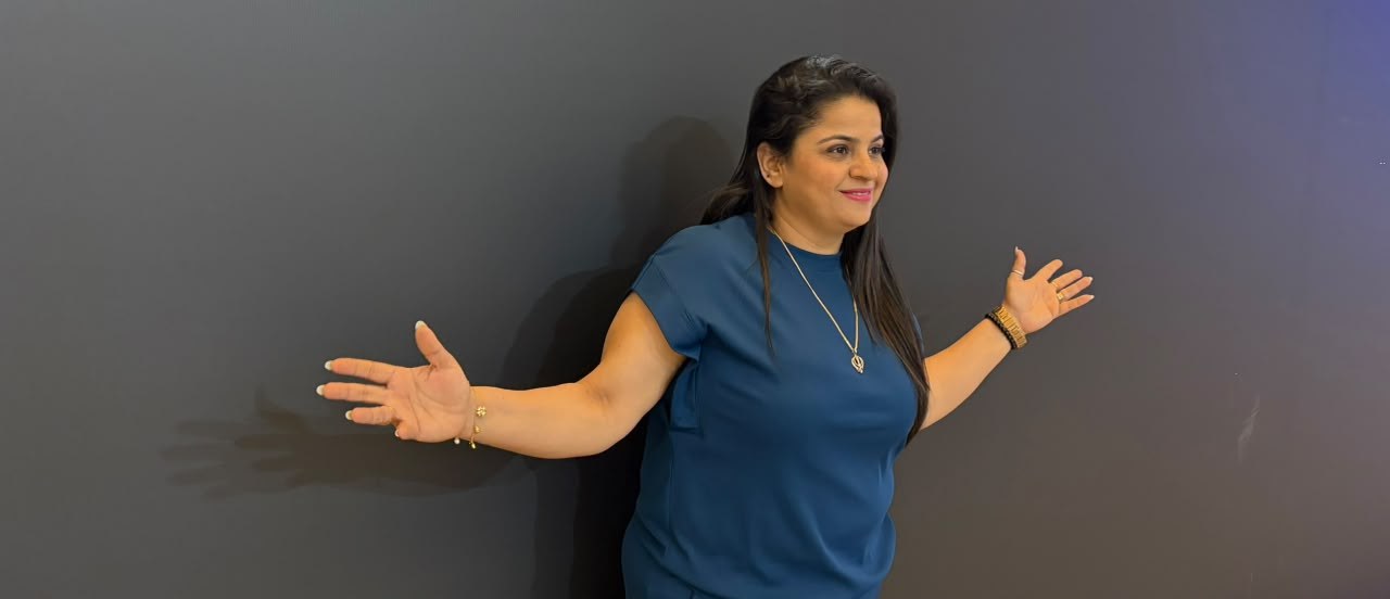 Shipra speaking with an open, welcoming gesture