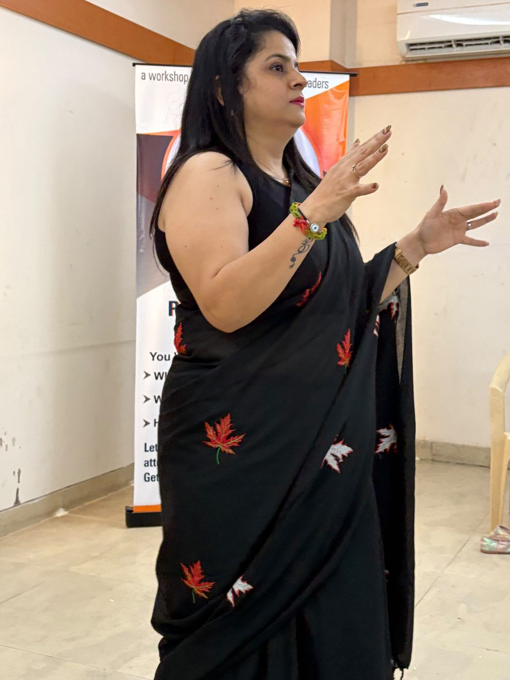 Shipra gesturing while delivering a session