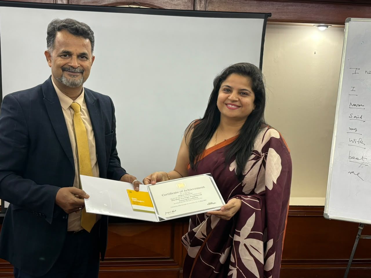 Shipra smiling while receiving a certificate